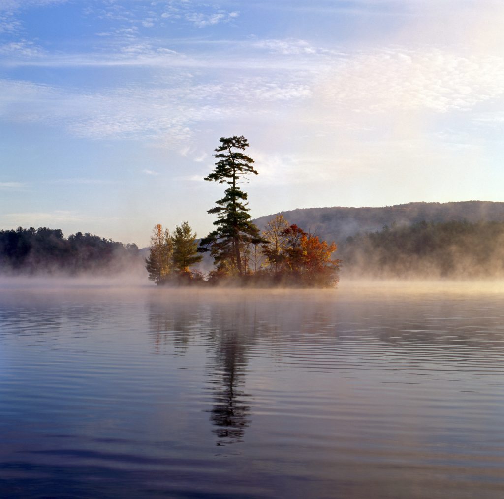 small island with autumn foliage lake george ny with fog