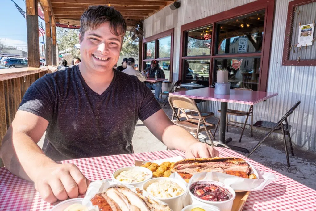 jeremy storm with a plate of barbecue in blanco texas