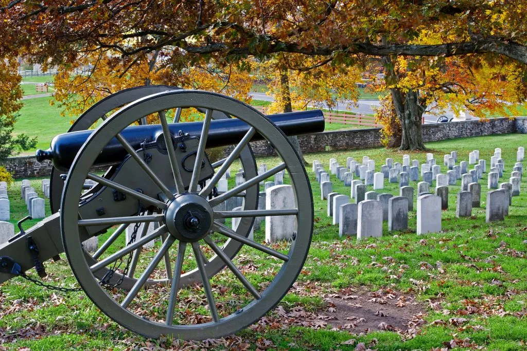 cannon in front of a grouping of headstones in gettysburg national military park