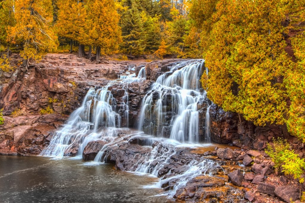 upper gooseberry falls in minnesota during fall foliage season