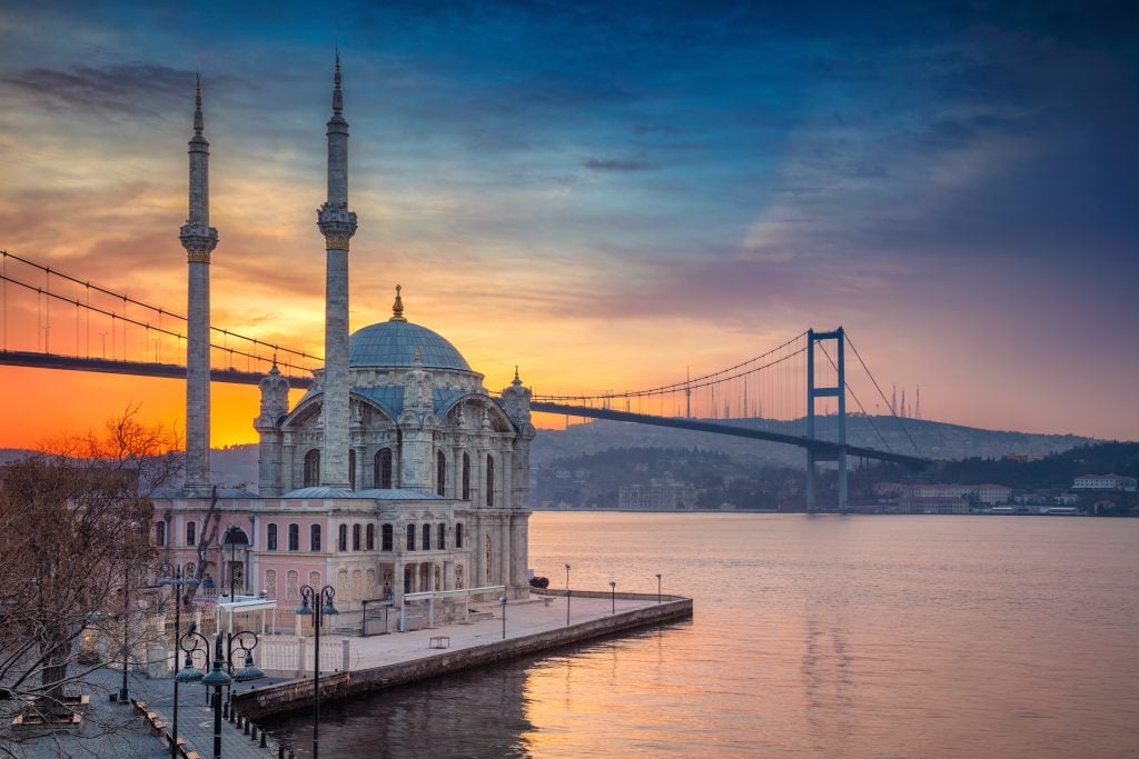 ortakoy mosque at sunset with bridge in the background, one of the best attractions in istanbul turkey