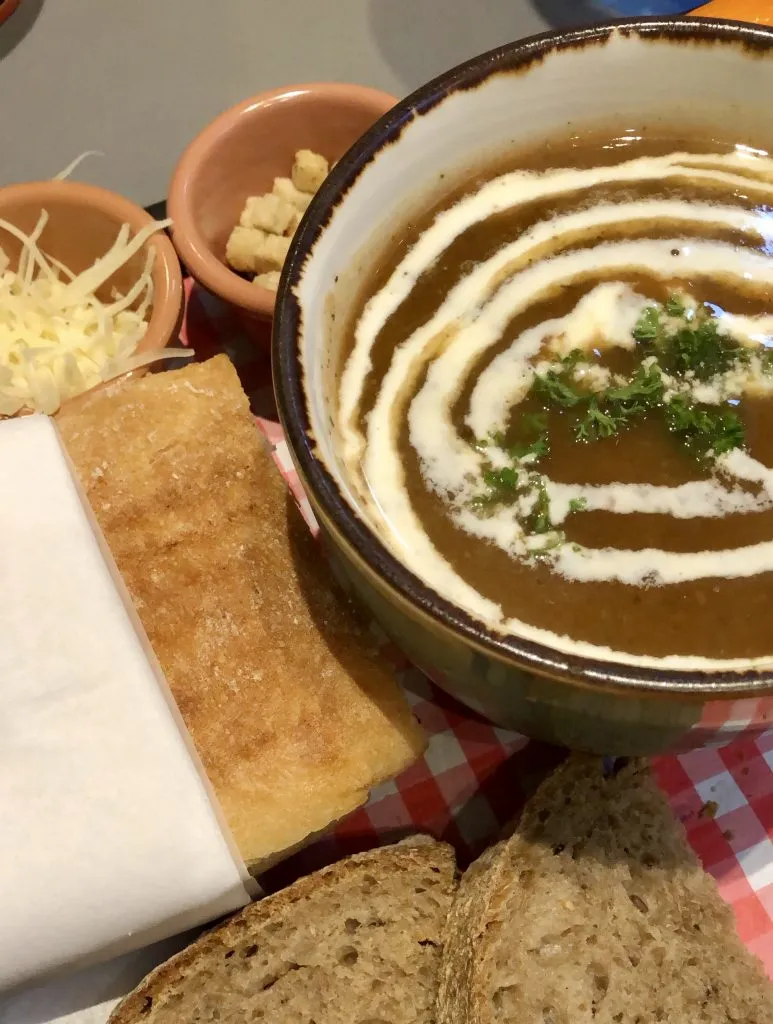 bowl of tomato soup with a panini at a belgium soup restaurant