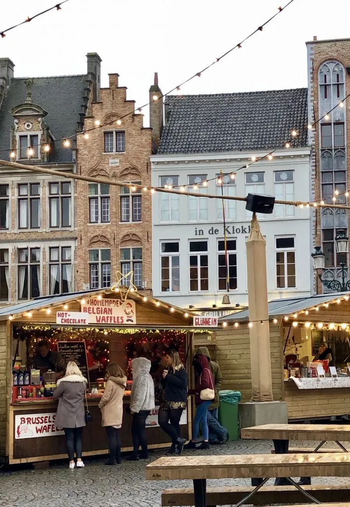 people shopping at a belgium christmas market in bruges