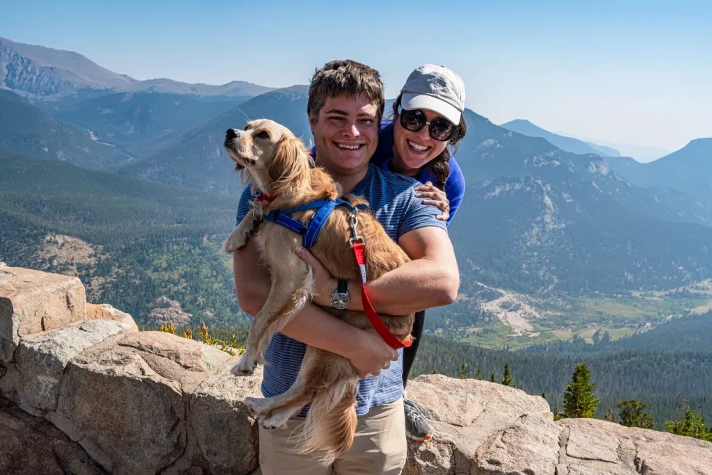 kate storm jeremy storm and ranger storm at an overlook in rocky mountain np with mountains in the background