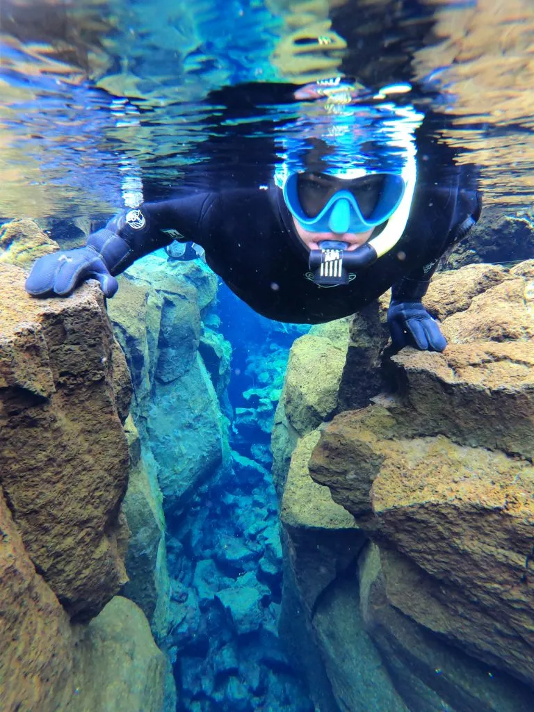 jeremy storm on a silfra snorkeling tour as seen underwater