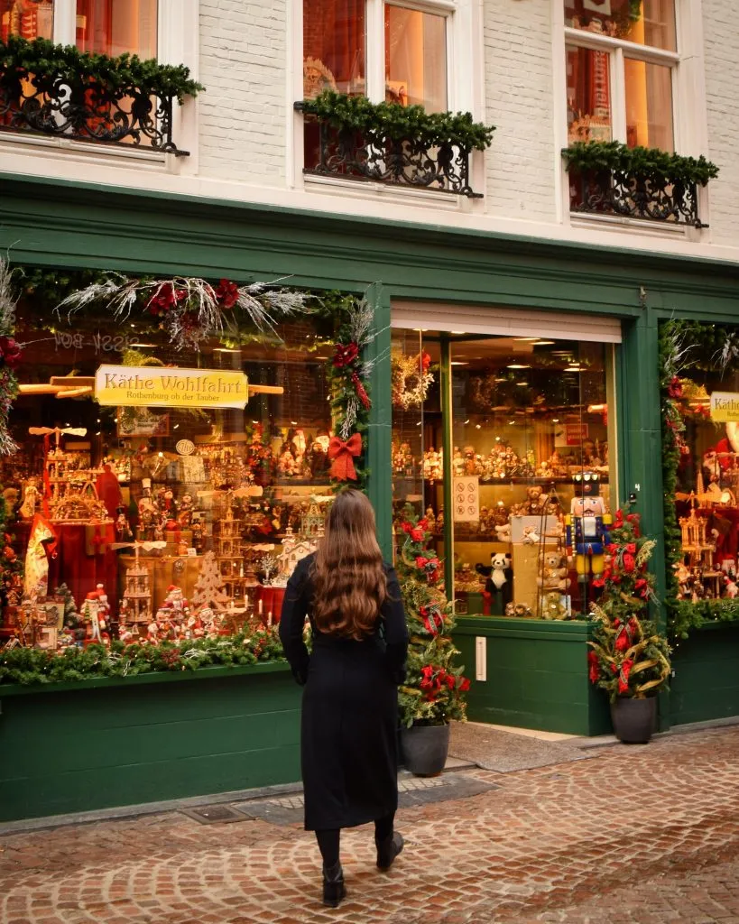 kate storm in front of a christmas store in bruges belgium november