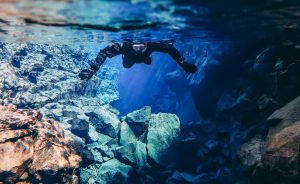 person in silfra snorkeling in iceland