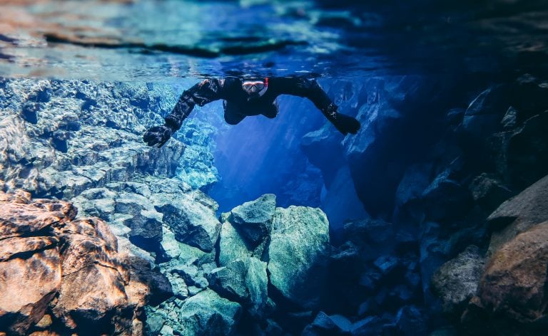 person in silfra snorkeling in iceland