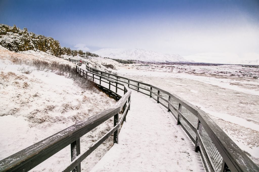 snow covered path leading to silfra fissure in thingvellir national park