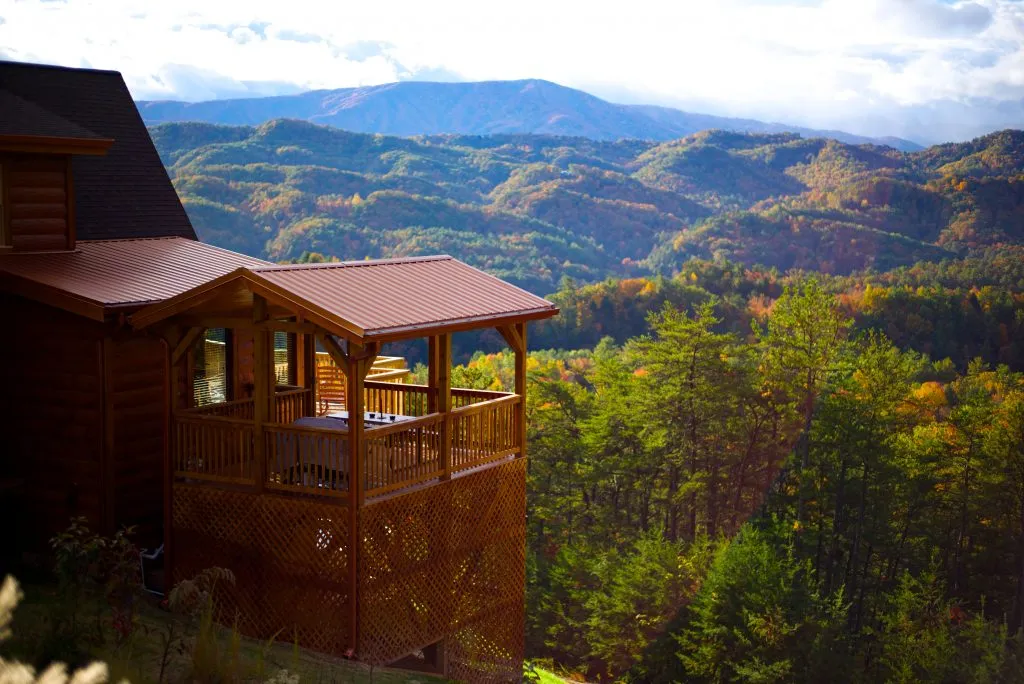 view of blue ridge mountains georgia in early fall with a cabin in the foreground