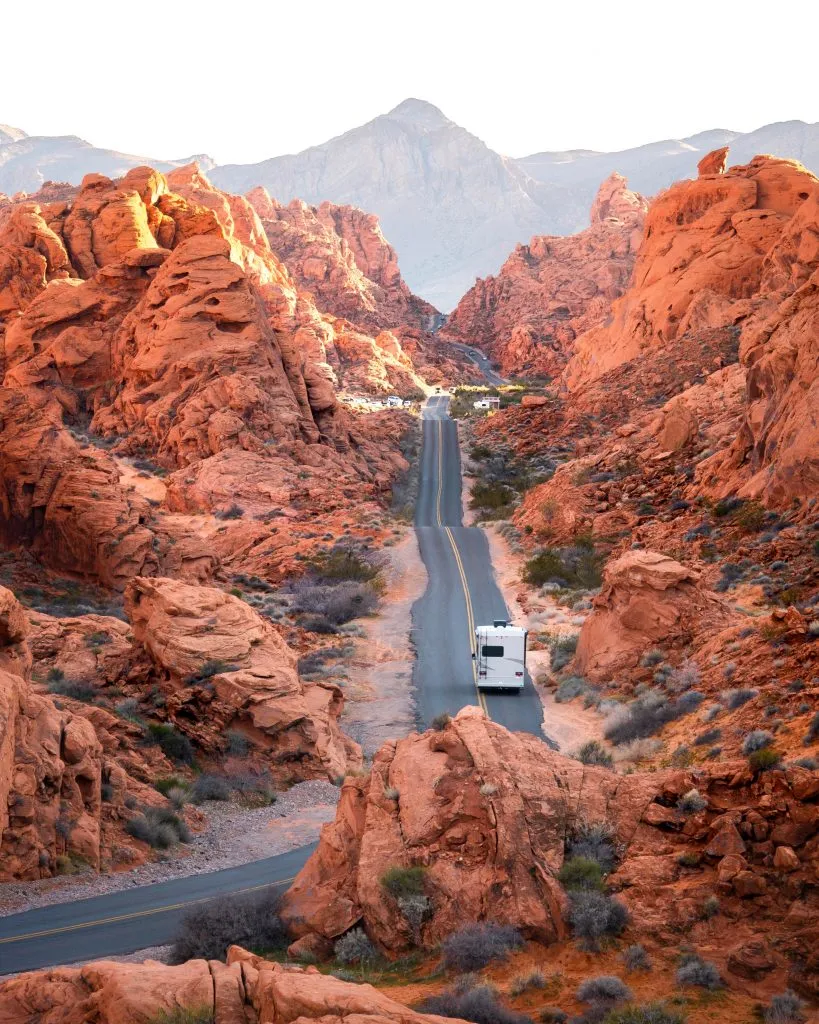 view of an rv driving through valley of fire state park, one of the best day trips during 3 days in las vegas nevada