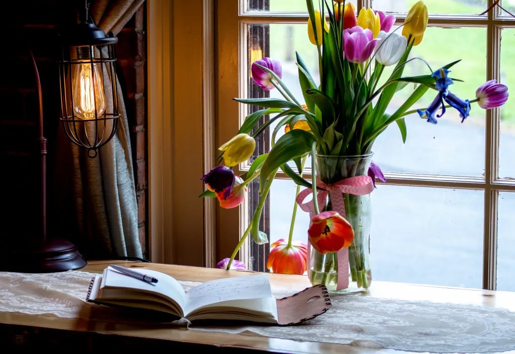 beautiful travel journaling prompt space with tulips in a vase