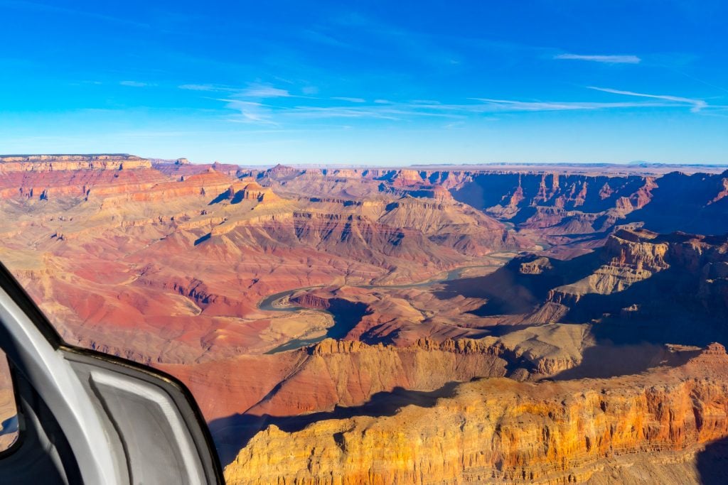 view of the grand canyon arizona from a helicopter on a sunny day