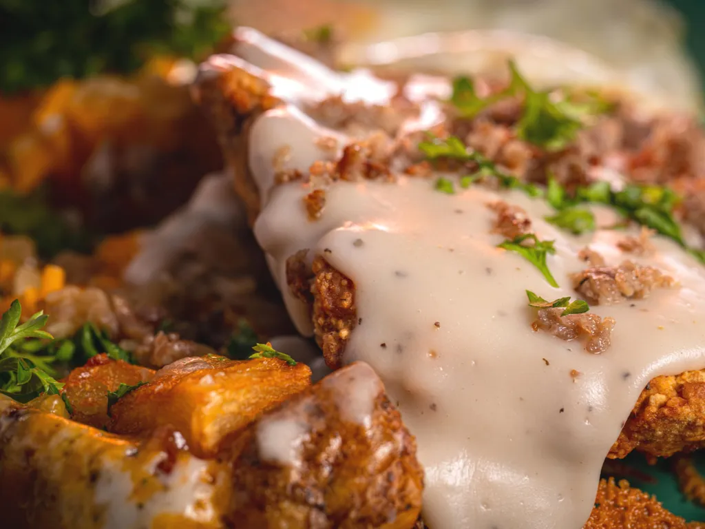 close up of a hash breakfast covered in gravy