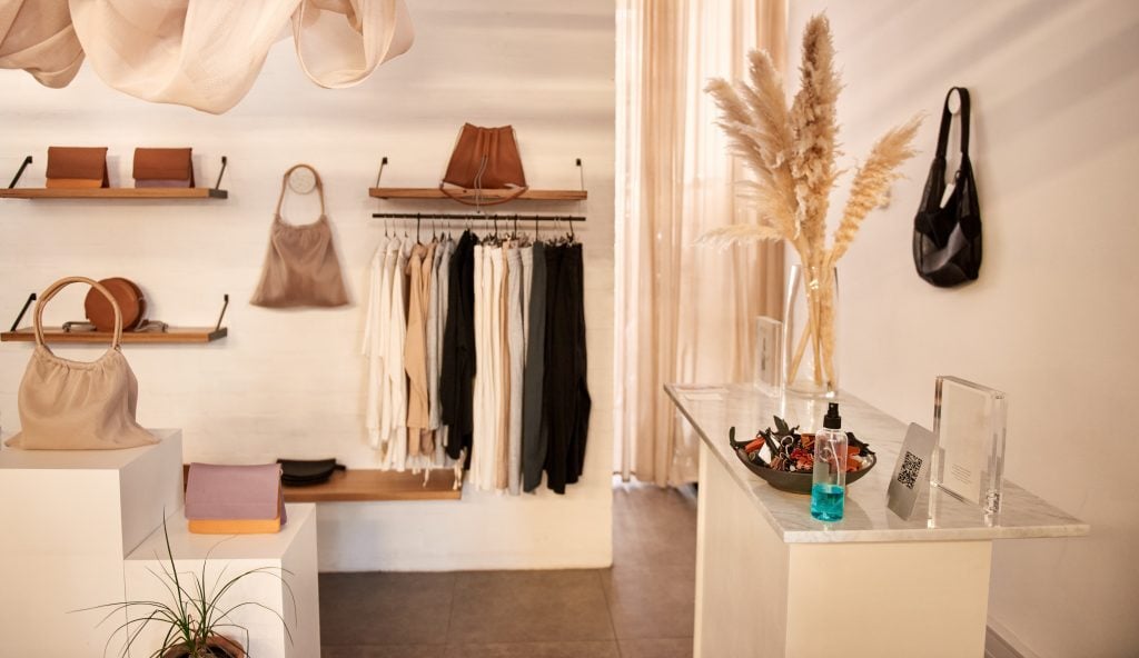 accessories on display in a trendy boutique with white walls