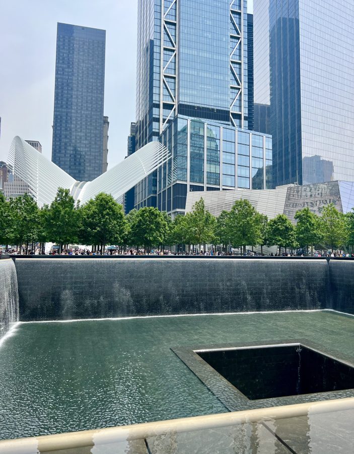 9/11 memorial with oculus and skyscrapers visible in the background