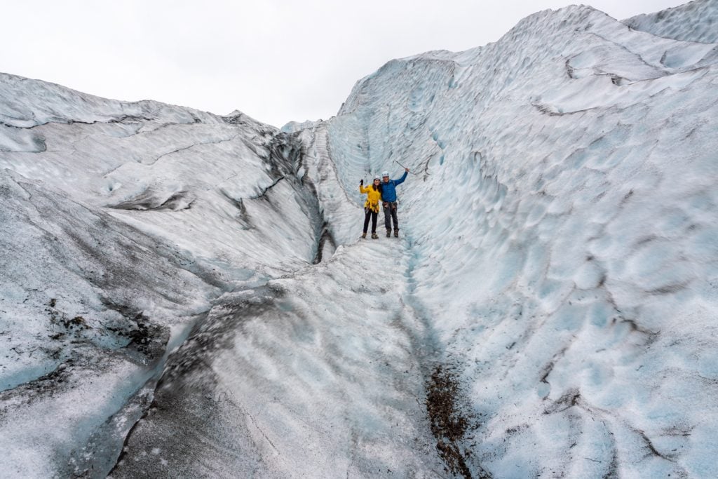 kate storm and jeremy storm hiking on glacier, one of the best things to do iceland