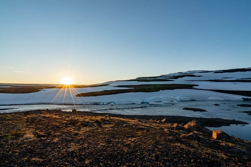 sunset over an icy lake in east fjords iceland ring road