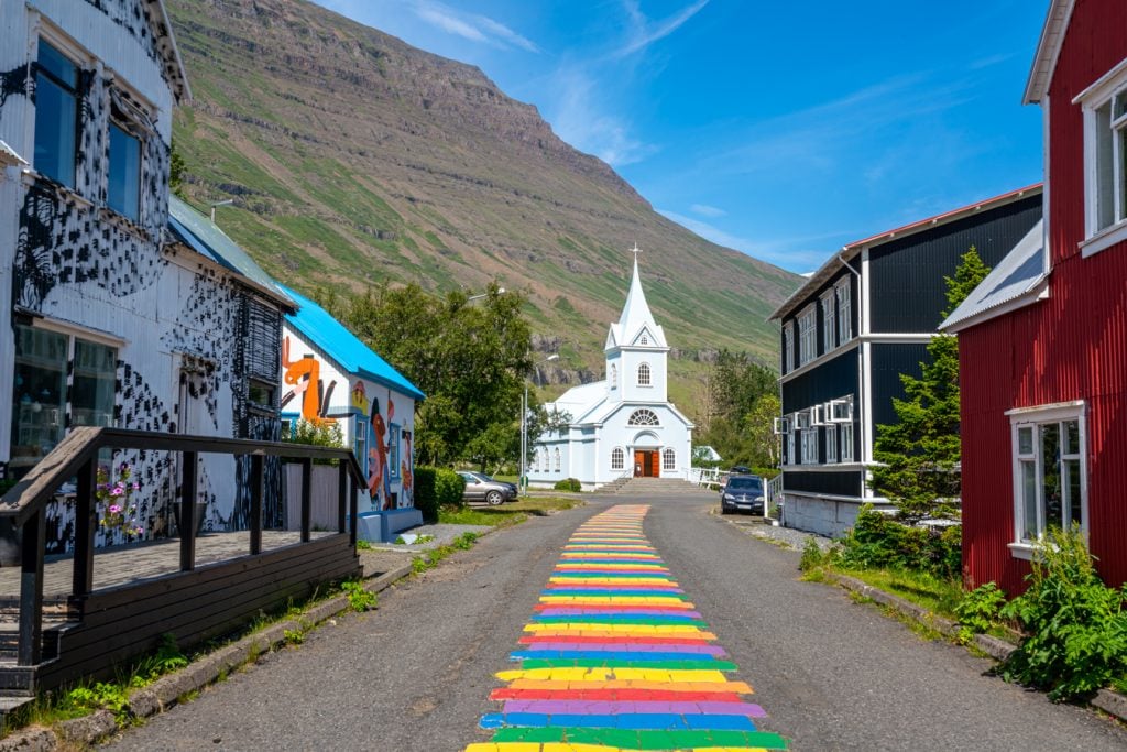 rainbow road leading to church in Seydisfjordur, planning a trip to iceland
