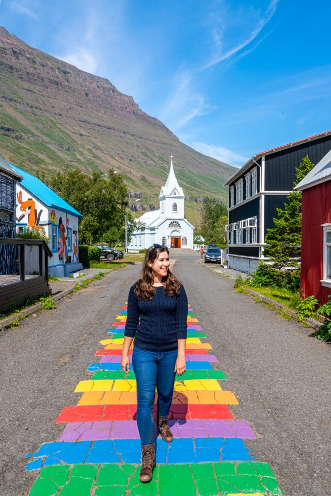 kate storm walking down rainbow street on an iceland road trip itinerary in 10 days