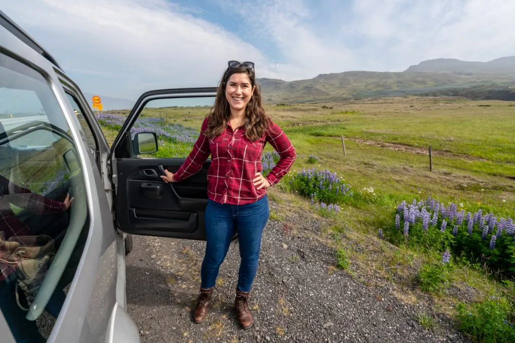 kate storm standing with gray jeep during an itinerary for iceland ring road
