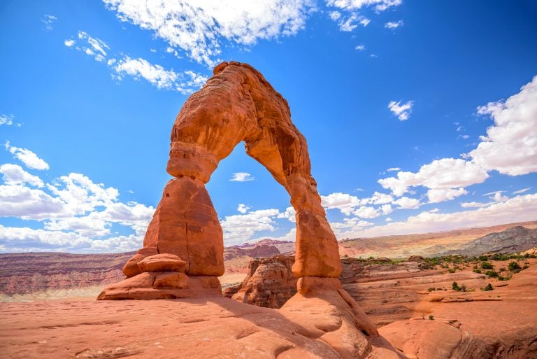 view of delicate arch on a sunny day, one of the best attractions with one day in arches national park itinerary