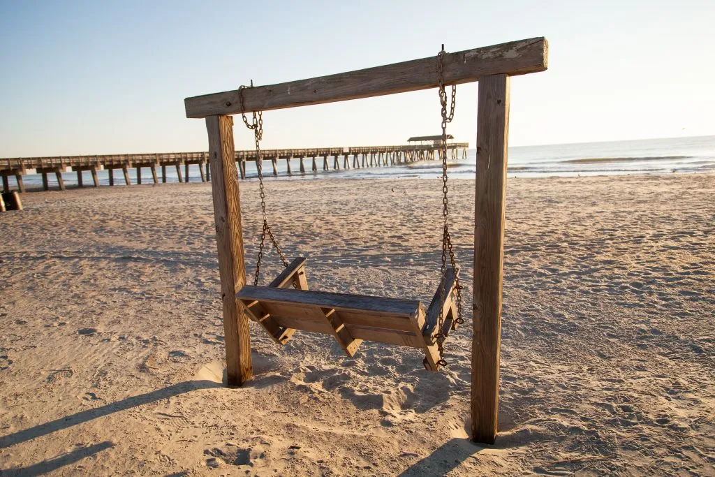 wooden swing on tybee beach near savannah georgia