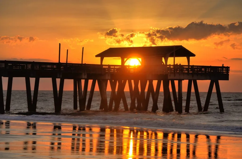 bright orange sunset at tybee pier at savannah beach at night