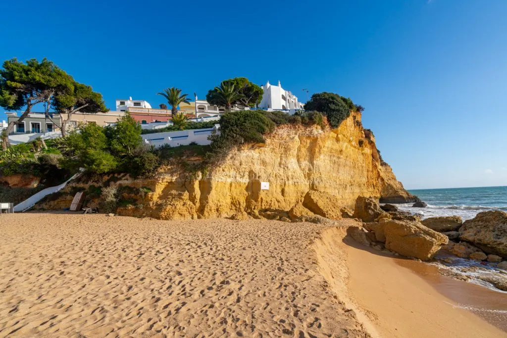 cliff overlooking sandy beach in carvoeiro portugal