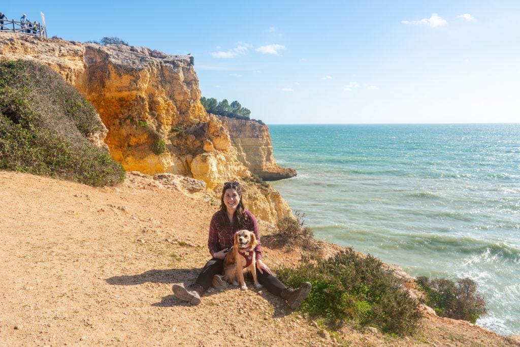 kate storm and ranger storm sitting along the seven hanging valleys trail, one of the best things to do in algarve portugal