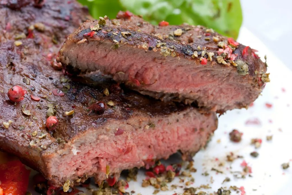 new york strip steak served on a white plate