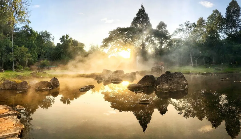 steam rising from water in hot springs national park at sunset, one of the most underrated vacation spots in usa