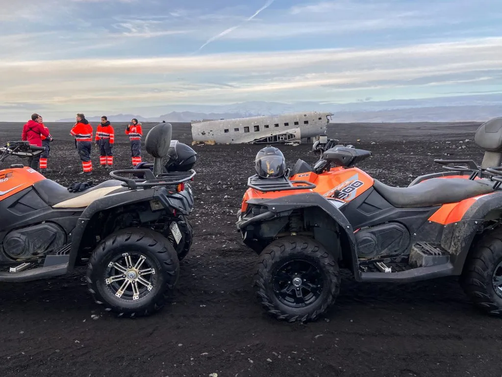 two atvs parked in front of beach plane crash in iceland activities
