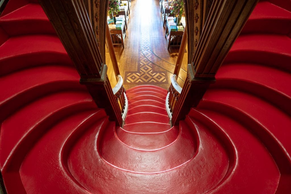 close up of red staircase livraria lello porto portugal