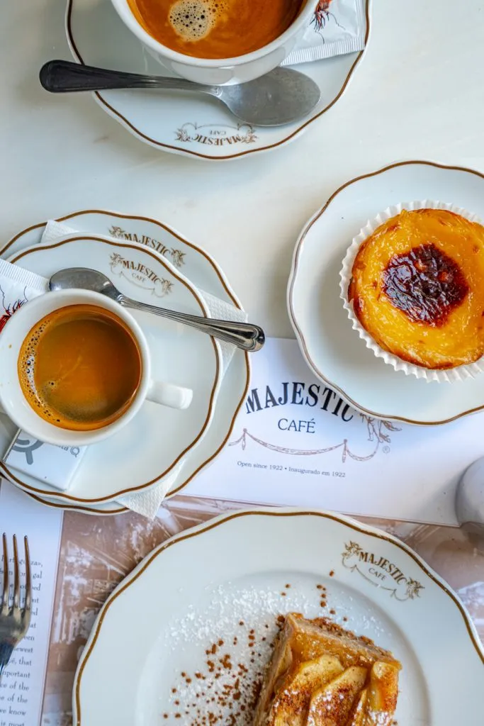 cake and coffee spread on the table in majestic cafe during one day in porto portugal