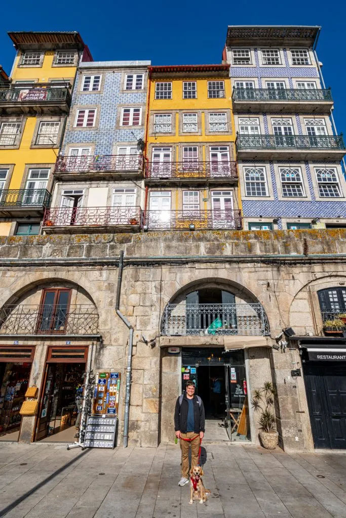 jeremy storm and ranger sotrm in front of colorful buildings ribeira riverfront, one day in porto itinerary