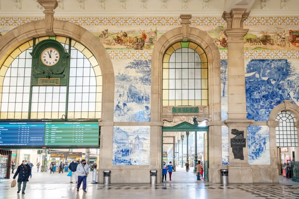 interior of sao bento porto with azulejos and clock, a must on any one day porto itinerary