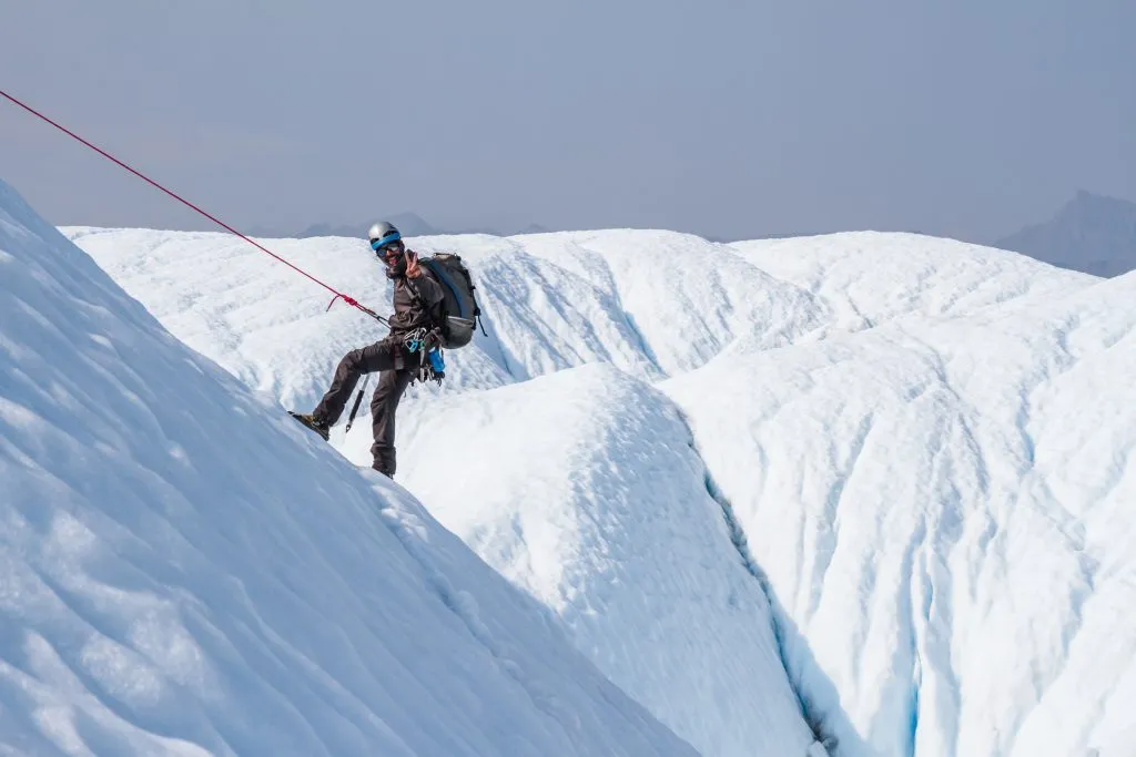 person ice climbing on a glacier in iceland