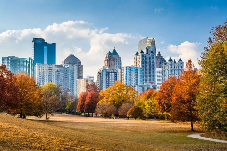 fall foliage in piedmont park with atlanta skyline, a fun stop during a long 3 day weekend in atlanta itinerary