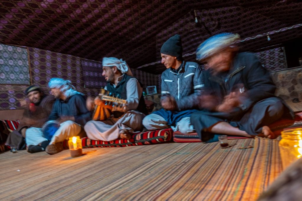 bedoin men playing instruments in a jordan wadi rum camp