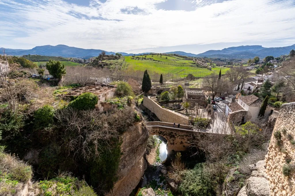 historic bridge overlooking andalusia spain countryside in ronda on an andalucia road trip itinerary