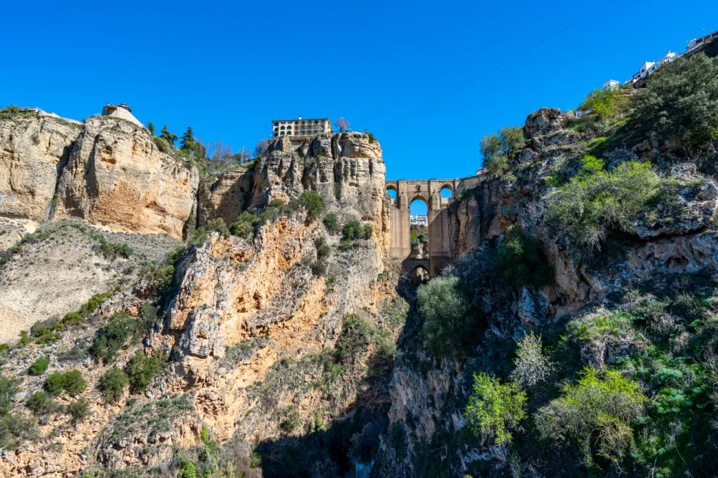 view of puerto nuevo ronda spain in the distance from inside gorge