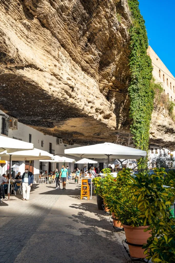 whitewashed buildings built into gorge in setenil de las bodegas spain, as seen on a south of spain itinerary