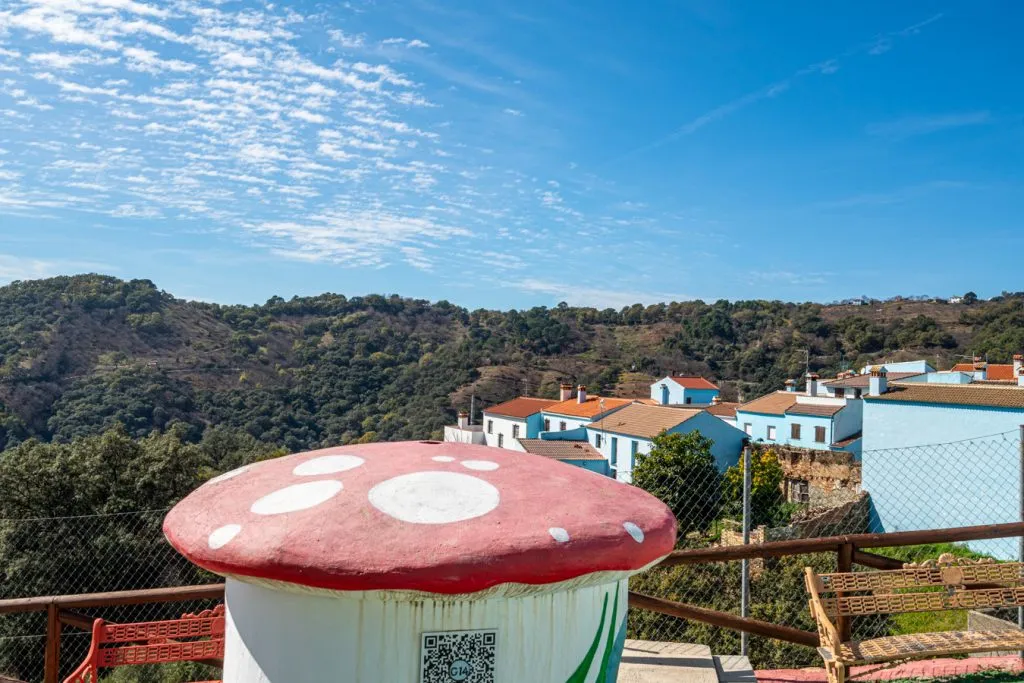 mushroom statue in juzcar spain with rolling hilles in the background