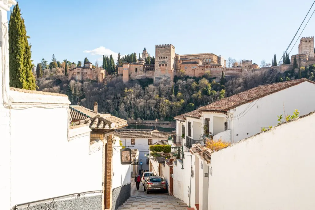 view of the alhambra from granada with whitewashed walls in the foreground