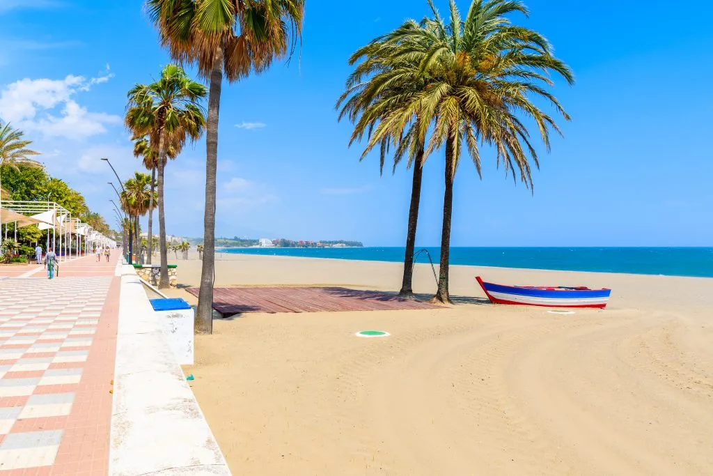 palm trees sandy beach and promenade in costal del sol spain itinerary
