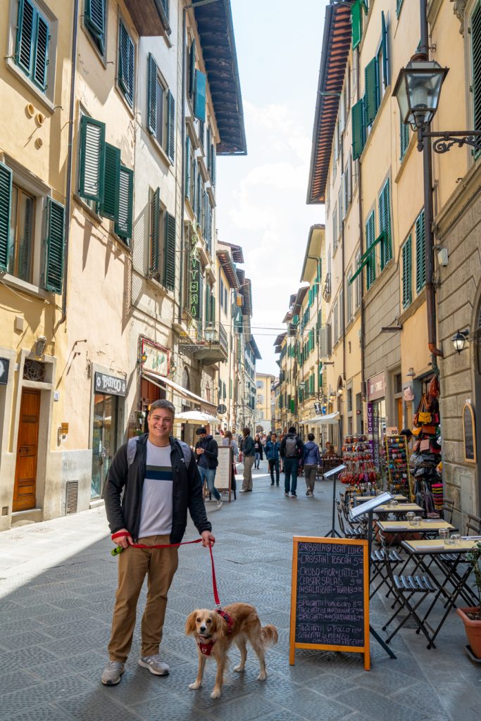 jeremy storm and ranger storm standing in front of a restaurant on a narrow street in florence italy
