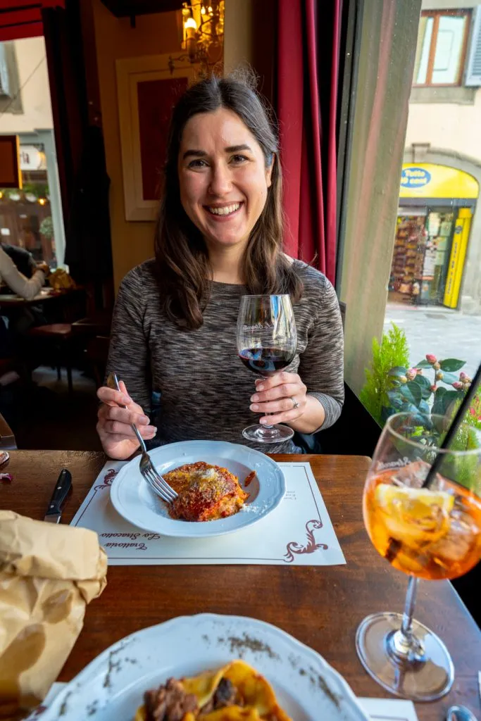 kate storm at a restaurant in florence with lasagna and red wine