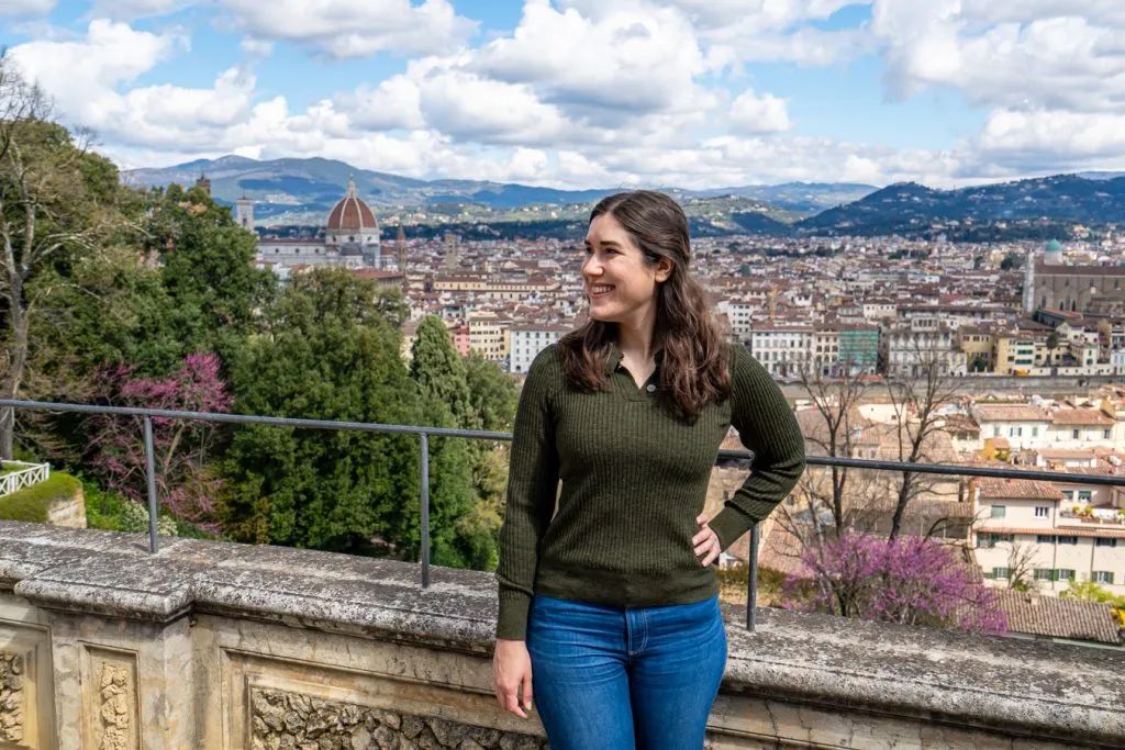 kate storm in a green sweater in the bardini gardens with view of florence italy behind her
