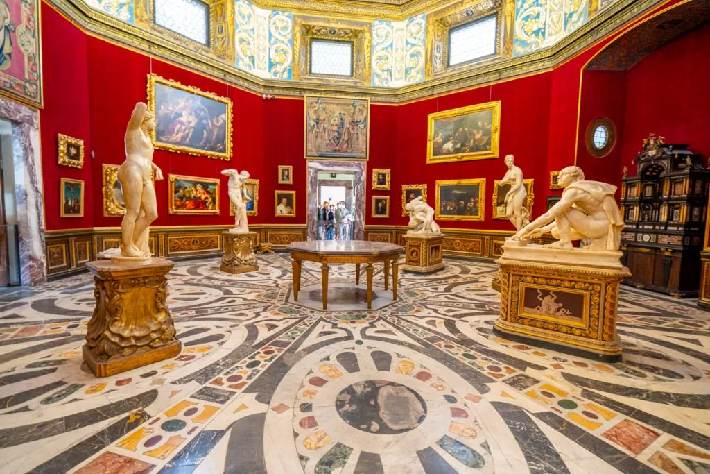 opulent interior of the uffizi gallery in florence with several statues